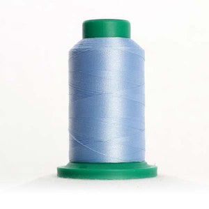 May include: A spool of light blue thread with a green plastic top and bottom.