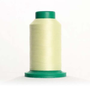 May include: A spool of pale yellow thread with a green plastic bobbin and a green plastic cap.