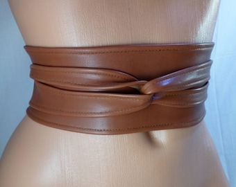 Brown leather obi belt that accentuates waistline • Leather wrap belt that creates hourglass figure • Versatile corset belt tied in a bow