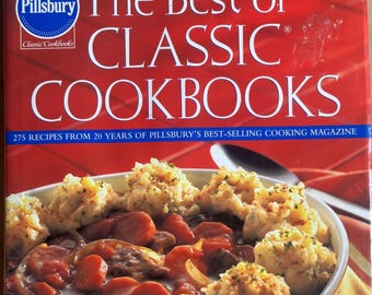 Könnte beinhalten: Ein gebundenes Buch Pillsbury The Best of CLASSIC COOKBOOKS mit rotem Einband, weißem Logo und Text. Das Cover zeigt eine Schüssel Rindfleischeintopf mit goldbraunen Klößen und den Text 275 RECIPES FROM 20 YEARS OF PILLSBURY'S BEST-SELLING COOKING MAGAZINE.