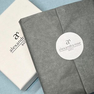 May include: Two white boxes with black text. The text on the top box reads "ar. alexandra bath". The text on the bottom box reads "ar. alexandra rose bath".