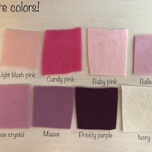 May include: Eight square felt fabric swatches arranged in two rows. The colors are labeled as Light blush pink, Candy pink, Baby pink, Ballerina, Rose crystal, Mauve, Prickly purple, and Ivory. The text More colors! appears at the top left.