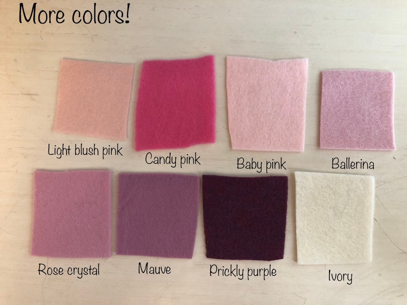 May include: Eight square felt fabric swatches arranged in two rows. The colors are labeled as Light blush pink, Candy pink, Baby pink, Ballerina, Rose crystal, Mauve, Prickly purple, and Ivory. The text More colors! appears at the top left.