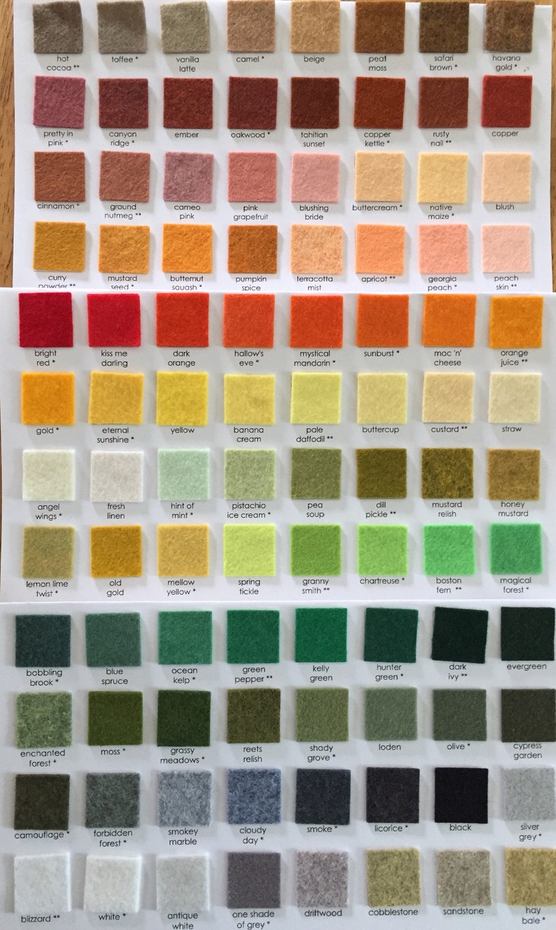 May include: A color chart featuring rows of small, square felt fabric swatches in various shades. Each swatch is labeled with a unique name, including colors like hot cocoa, bright red, and evergreen, arranged in a grid on a white background.
