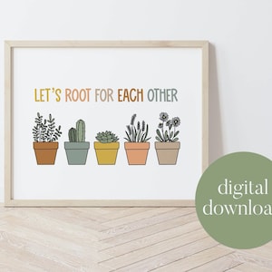 May include: A printable wall art print with the text "Let's Root For Each Other" and a row of five potted plants in various colors. The print is framed in a light wood frame and has a digital download label.