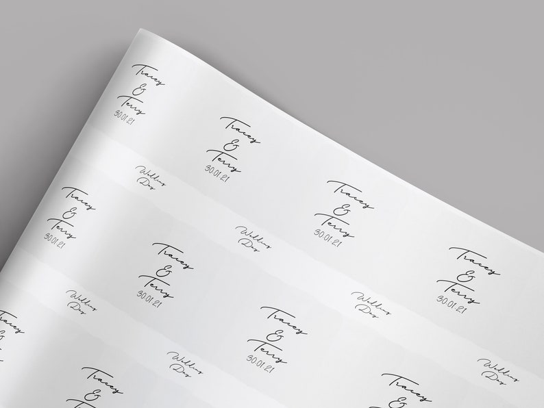 May include: White paper with repeating black text: "Tracey & Terry" and "30.01.21". The words "Wedding Day" are also printed on the paper. The paper is slightly angled, showing multiple instances of the text.