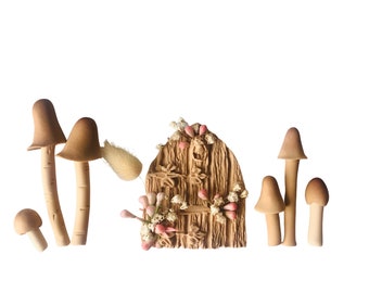 May include: A whimsical fairy door and mushroom set. The wooden door is intricately carved and adorned with delicate floral accents. Several wooden mushrooms of varying sizes surround the door, creating a miniature forest scene. The color palette is primarily natural wood tones with touches of pink and white.