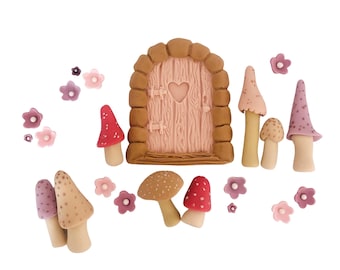 May include: A set of pink and purple fondant flowers and mushrooms, including a small pink door with a heart-shaped window, perfect for decorating a cake.