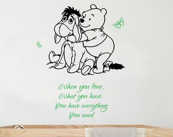 May include: Black and white Winnie the Pooh and Eeyore wall decal with the quote "When you love, what you have, you have everything you need".