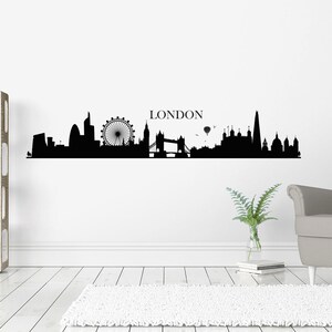 May include: Black and white silhouette of the London skyline, including the London Eye, Big Ben, Tower Bridge, and the Shard. The word "LONDON" is written above the skyline.