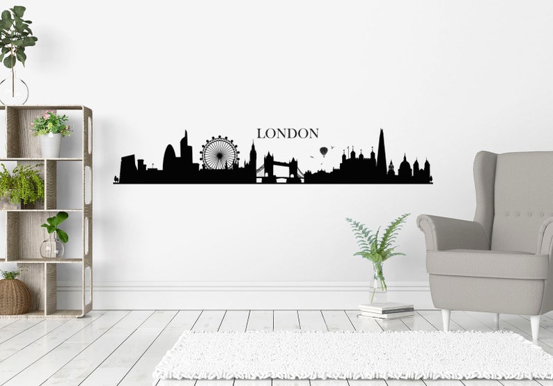 May include: Black and white silhouette of the London skyline, including the London Eye, Big Ben, Tower Bridge, and the Shard. The word "LONDON" is written above the skyline.