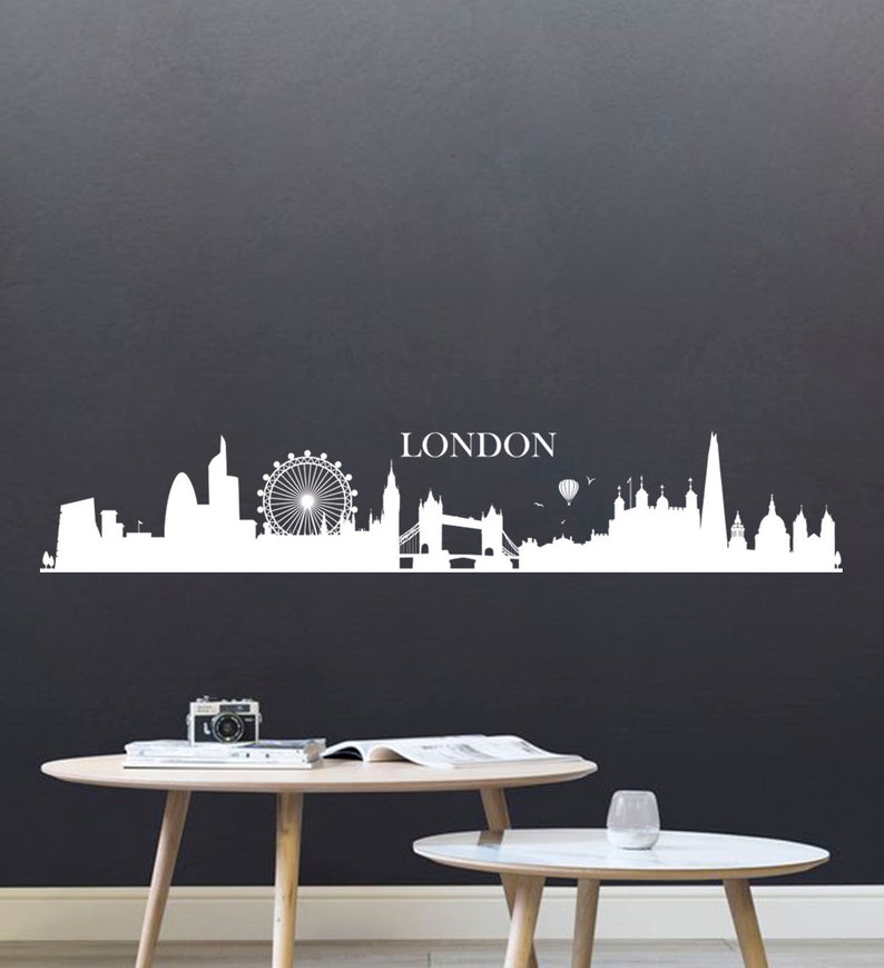 May include: White silhouette of the London skyline with the London Eye, Big Ben, Tower Bridge, and the Shard. The word "LONDON" is written above the skyline.
