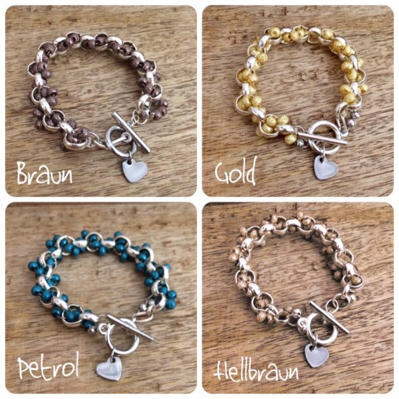 May include: Four silver bracelets with different colored beads. The bracelets have a silver toggle clasp and a silver heart charm. The colors of the beads are brown, gold, teal, and light brown.