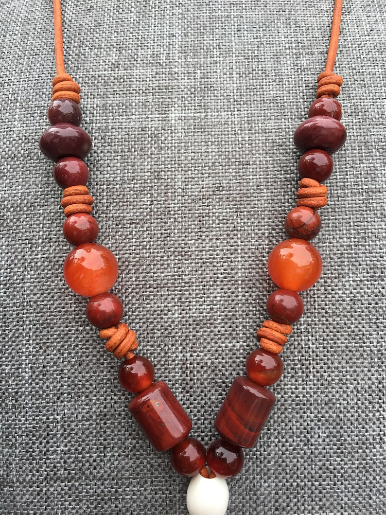 handcarved bone jewelry handmade jewelry red jasper carnelian gemstones brown leather mookite Chakra jewelry