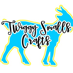 May include: A blue silhouette of a goat with a yellow outline. The text "Twiggy Smalls Crafts" is written in black cursive lettering over the goat.