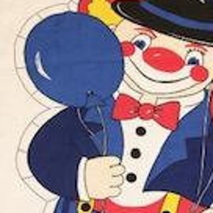 May include: A vintage fabric applique pattern featuring a clown with a red and blue hat, red and blue balloons, and a red bow tie. The clown is wearing a blue suit with white stripes and black shoes.