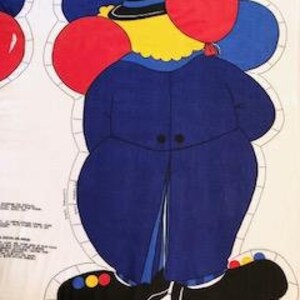 May include: A blue and yellow fabric applique of a clown holding red and blue balloons. The clown is wearing a blue jacket, a black hat, and black shoes with yellow and red accents.