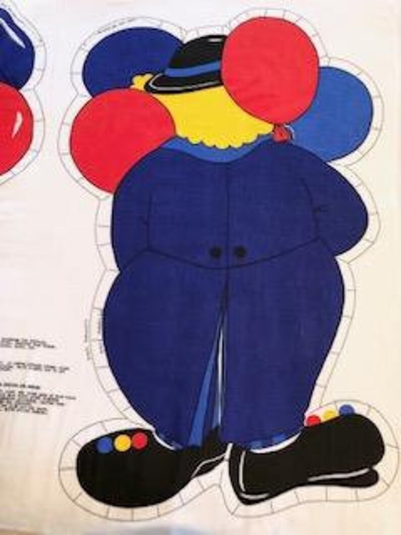 May include: A blue and yellow fabric applique of a clown holding red and blue balloons. The clown is wearing a blue jacket, a black hat, and black shoes with yellow and red accents.