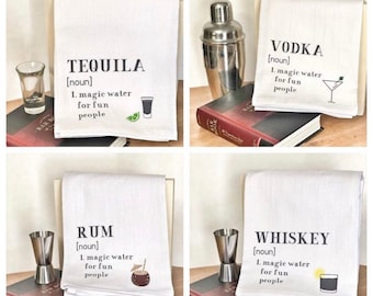 May include: Four white kitchen towels with black text and illustrations. Each towel features a different type of alcohol: Tequila, Vodka, Rum, and Whiskey. The text on each towel defines the alcohol as "magic water for fun people".
