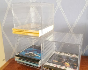 80s Acrylic CD shelves for 27 normal or 12 double CDs. Can be used lengthways or upright. There are more sets available in my shop. 3 cubes