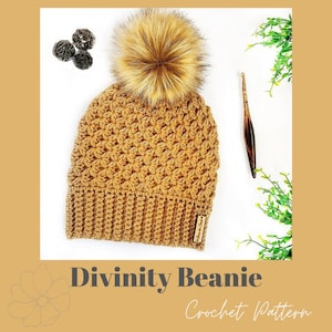 May include: A crocheted beanie in a warm brown color with a fluffy brown pom pom on top. The beanie is made with a textured stitch pattern and has a label that says "Love the Crochet".