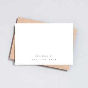 May include: A white card with the text "DESIGNED BY THE TYPE CLUB" printed in black.