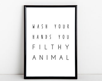 Puede incluir: Impresión enmarcada en blanco y negro con el texto "WASH YOUR HANDS YOU FILTHY ANIMAL" en una fuente minimalista.