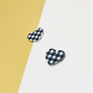 May include: Two black and white gingham heart-shaped charms.