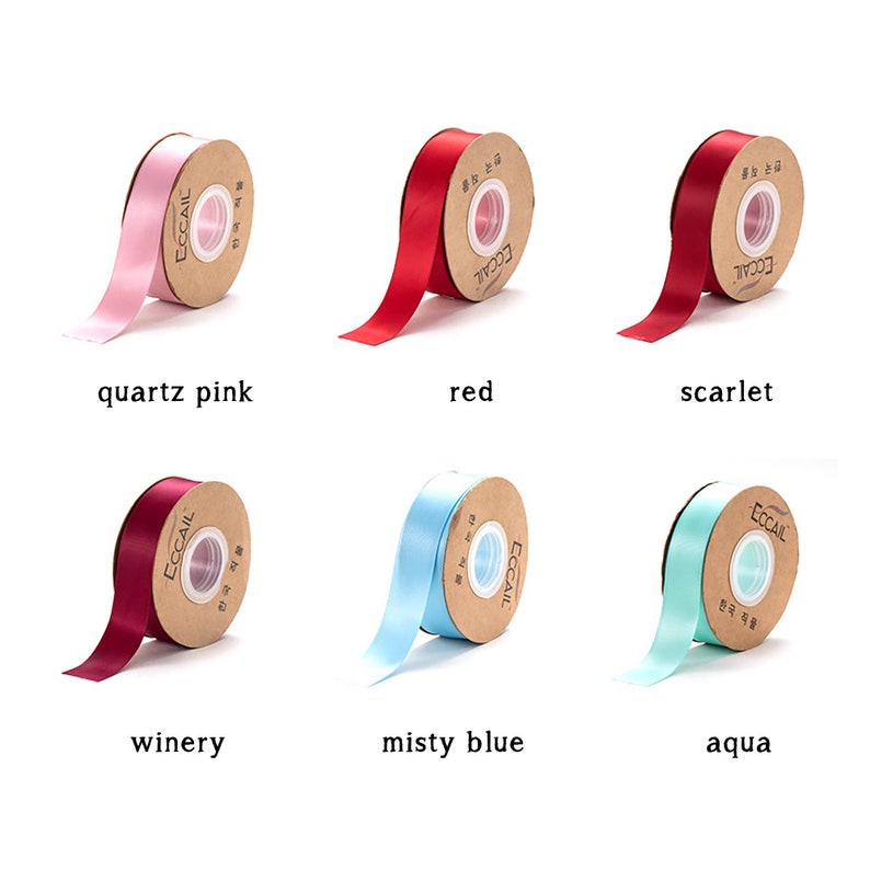 May include: Six spools of satin ribbon in various colors, including quartz pink, red, scarlet, winery, misty blue, and aqua. Each spool is wrapped in brown paper with the word "ECCAIL" printed on it.
