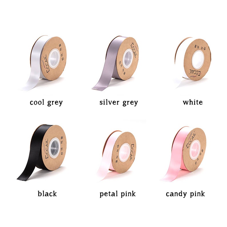 May include: Assortment of satin ribbon spools in various colors, including cool grey, silver grey, white, black, petal pink, and candy pink. Each spool has a brown paper label with the word "ECCAIL" printed on it.