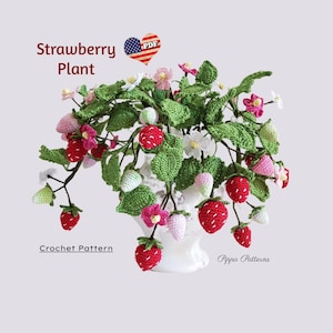 May include: Crochet pattern for a strawberry plant. The plant is made of green and red yarn and has white flowers. The pattern is available as a PDF download. "Strawberry Plant" and "Crochet Pattern" are written on the image.
