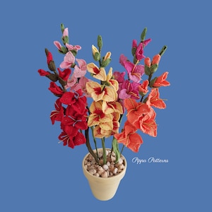 May include: A bouquet of crocheted gladiolus flowers in a variety of colors, including red, orange, yellow, pink, and white. The flowers are arranged in a terracotta pot with white stones.