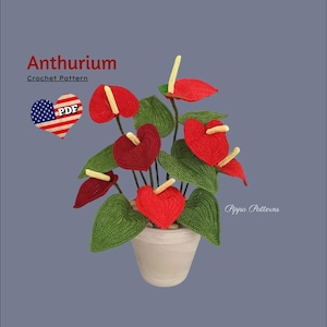 May include: A crochet pattern for an Anthurium plant. The pattern is available as a PDF download. The plant is red and green and is in a white pot.