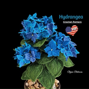 May include: A crocheted hydrangea plant in a pot with green leaves and blue flowers. The pattern is available as a PDF download. The text on the image reads "Hydrangea Crochet Pattern PDF".