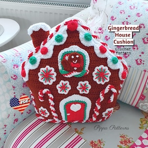 May include: Crochet pattern for a gingerbread house cushion. The cushion is brown with white frosting, red candy canes, and green and red candy dots. The pattern is available as a PDF download.