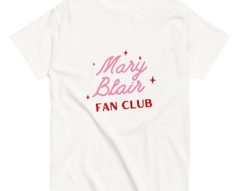 May include: White t-shirt with a pink and red graphic that says "Mary Blair Fan Club" with red stars.