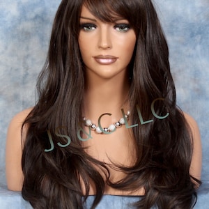 May include: A long, dark brown wig with a side part and bangs. The wig is styled in loose waves and has a natural-looking finish.