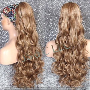 May include: A long, wavy, light brown hair extension with a black and white patterned headband. The hair extension is styled in a ponytail.