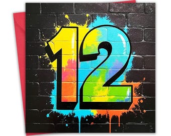 May include: A birthday card with a black brick wall background and the number 12 in graffiti style. The number is outlined in black and filled with yellow, blue, and green paint. A red envelope is visible.
