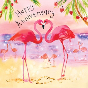 May include: A pink greeting card with the text "Happy Anniversary" and a watercolor illustration of two pink flamingos with their necks intertwined in a heart shape. The flamingos are standing on a beach with a pink and purple sky in the background.
