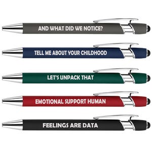 May include: A set of five retractable ballpoint pens with chrome accents and stylus tips. Each pen features a matte barrel in gray, blue, green, red, or black, printed with white text: AND WHAT DID WE NOTICE?, TELL ME ABOUT YOUR CHILDHOOD, LET'S UNPACK THAT, EMOTIONAL SUPPORT HUMAN, and FEELINGS ARE DATA.