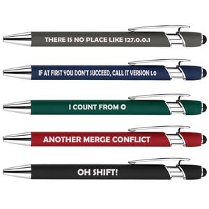 May include: Five retractable ballpoint pens with silver-tone clips and stylus tips. The pens are gray, blue, green, red, and black, each featuring white text: THERE IS NO PLACE LIKE 127.0.0.1, IF AT FIRST YOU DON'T SUCCEED, CALL IT VERSION 1.0, I COUNT FROM 0, ANOTHER MERGE CONFLICT, and OH SHIFT!