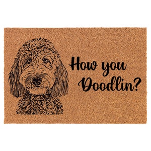 May include: A brown coir doormat with a black and white illustration of a doodle dog and the text "How you Doodlin?"