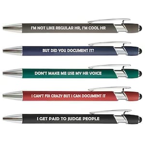May include: A collection of five ballpoint pens with silver accents and black touch tips. Each pen has a different colored barrel and a humorous phrase in white text: "I'M NOT LIKE REGULAR HR, I'M COOL HR", "BUT DID YOU DOCUMENT IT?", "DON'T MAKE ME USE MY HR VOICE", "I CAN'T FIX CRAZY BUT I CAN DOCUMENT IT", and "I GET PAID TO JUDGE PEOPLE".