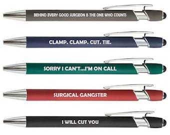 May include: A set of five retractable ballpoint pens in grey, navy blue, teal, red, and black. Each pen features a silver clip, a stylus tip, and white text: BEHIND EVERY GOOD SURGEON IS THE ONE WHO COUNTS, CLAMP. CLAMP. CUT. TIE., SORRY I CAN'T...I'M ON CALL, SURGICAL GANGSTER, and I WILL CUT YOU.