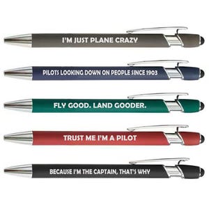 May include: Five ballpoint pens with silver accents and black touch tips. Each pen has a different color barrel and a humorous aviation-themed quote: "I'M JUST PLANE CRAZY", "PILOTS LOOKING DOWN ON PEOPLE SINCE 1903", "FLY GOOD. LAND GOODER.", "TRUST ME I'M A PILOT", and "BECAUSE I'M THE CAPTAIN, THAT'S WHY".