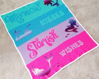 May include: A crocheted blanket with a mermaid theme. The blanket is made of different colored stripes of yarn, with each stripe featuring a different mermaid-related image and text. The stripes are turquoise, blue, purple, and pink. The text on the blanket reads "Mermaid Wishes", "Starfish", and "Wishes".