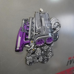 May include: A detailed illustration of a car engine, featuring purple and gray components. The engine design includes the brand name "NISSAN". The image is mounted on a gray surface.
