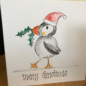 Carte de macareux de Noël illustrée à la main. Peut être personnalisé.