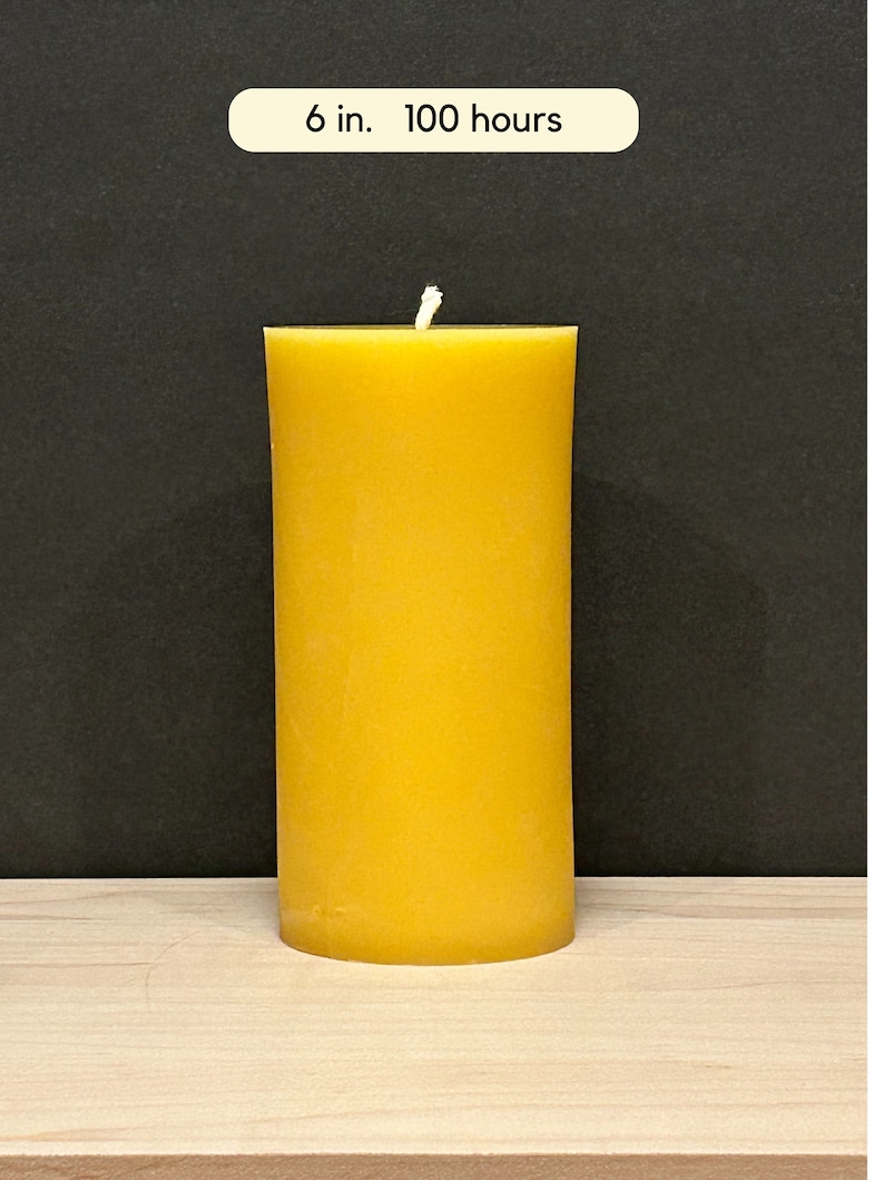 May include: A large, yellow beeswax candle with a white wick. The candle is 6 inches tall and has a burn time of 100 hours.
